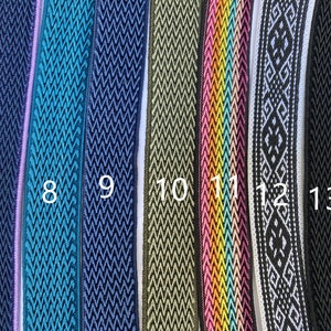 May include: Close-up of eight different types of woven trim, in various colors and patterns, including teal, navy, green, pink, and white. The trim is numbered 7 through 13.