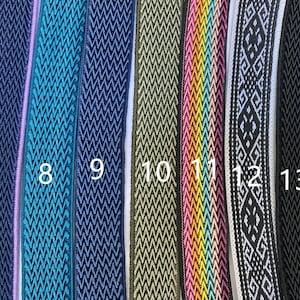 May include: Close-up of eight different types of woven trim, in various colors and patterns, including teal, navy, green, pink, and white. The trim is numbered 7 through 13.