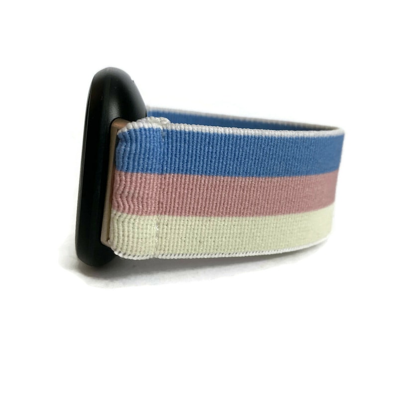 May include: A black watch band with a striped pattern in blue, pink and white.