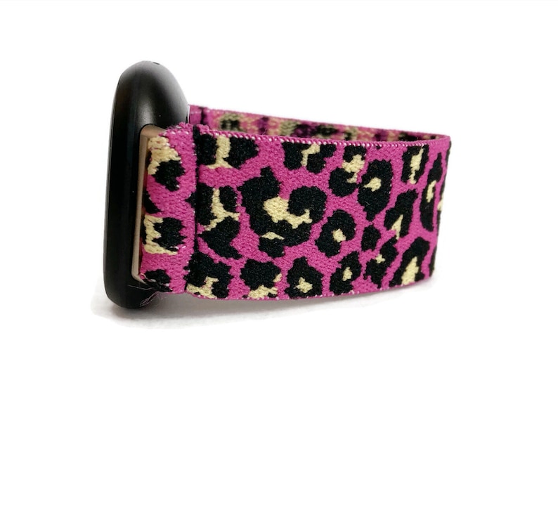 May include: A pink and black leopard print watch band with a black watch face.