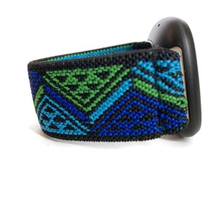 May include: A black fitness tracker with a blue, green, and black patterned elastic band.