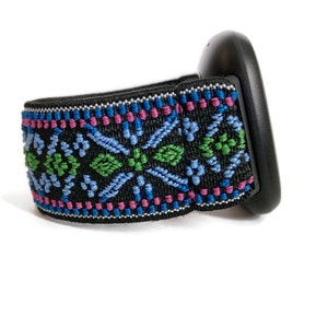 May include: Black headband with a colourful geometric pattern in shades of blue, green, and pink.