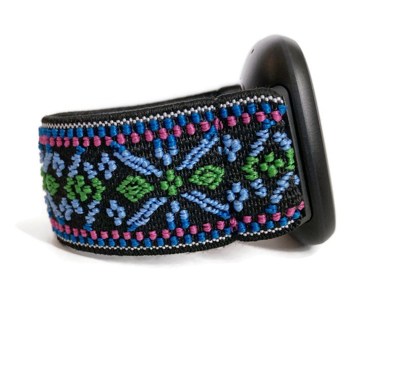 May include: Black headband with a colourful geometric pattern in shades of blue, green, and pink.