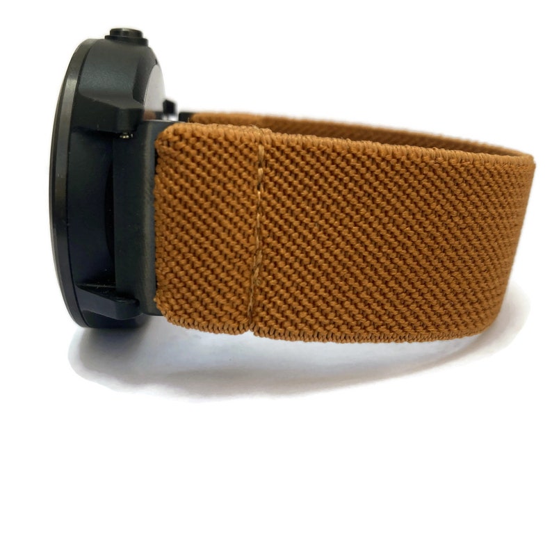May include: A black smartwatch with a brown elastic band.