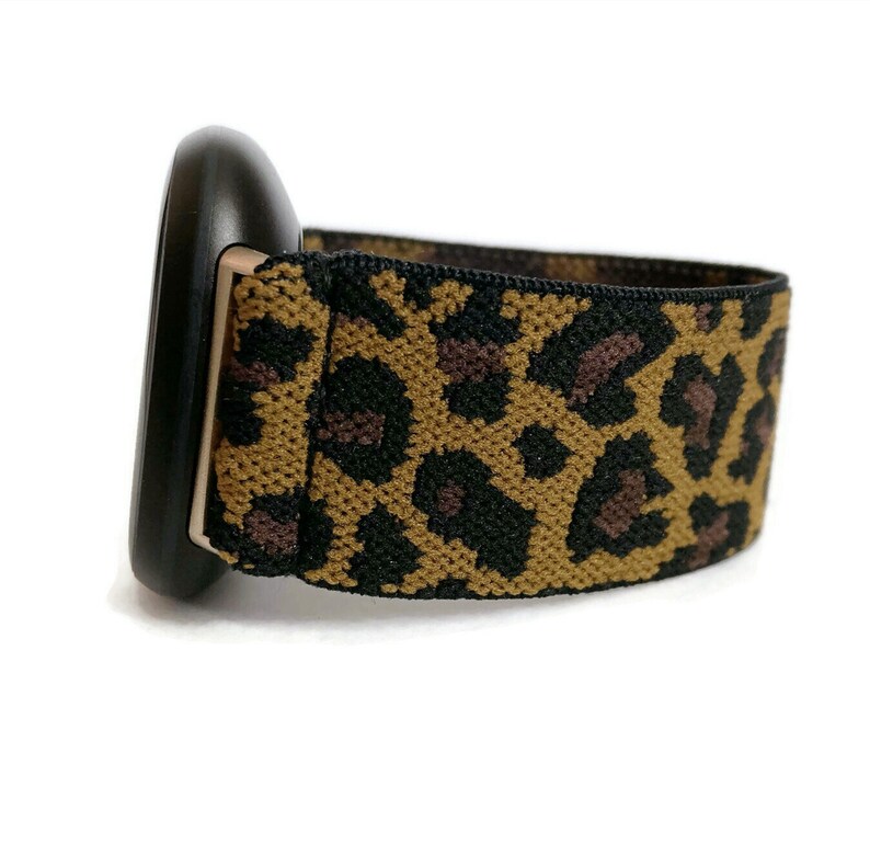 May include: A black and brown leopard print elastic watch band.