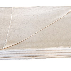 May include: A folded white cotton drop cloth, a versatile fabric used for protecting surfaces during painting or other messy projects.