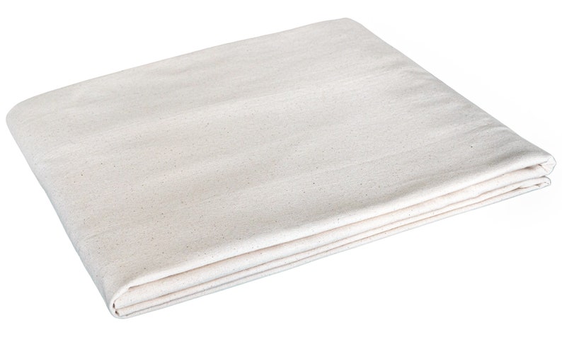 May include: A folded white cotton drop cloth, a versatile and durable fabric used for protecting surfaces during painting or other messy projects.