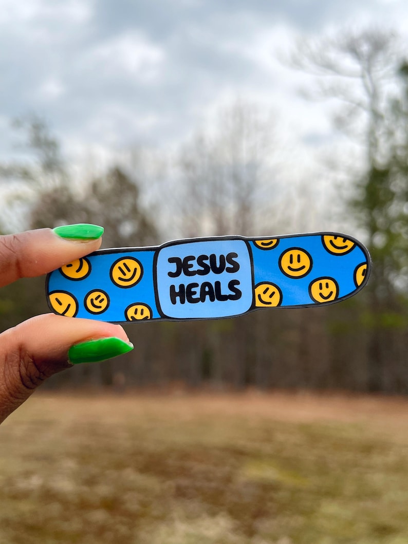 May include: Blue and yellow band-aid sticker with the text "JESUS HEALS" and a pattern of smiley faces.