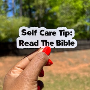 May include: White sticker with black text that reads "Self Care Tip: Read The Bible".
