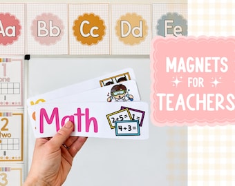 May include: A hand holding a white magnet with the word "Math" in pink. The image also shows alphabet and number learning tools, and a pink sign that says "Magnets for Teachers".