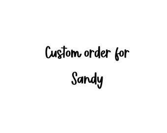 May include: A set of three ceramic mugs with a speckled, matte finish. The mugs are in shades of cream, light brown, and dark brown. Each mug has a simple, minimalist design, perfect for coffee or tea.