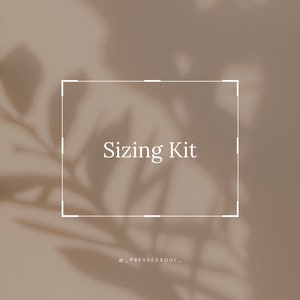 May include: A white rectangle with the text "Sizing Kit" inside. The rectangle is on a beige background with a shadow of a plant.