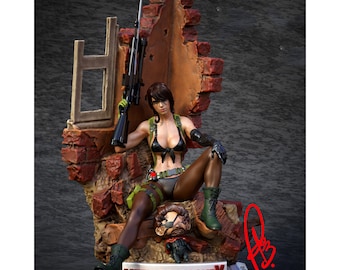 May include: A detailed figurine of a female character from the Metal Gear Solid video game series. She is wearing a black bikini top, green camouflage trousers, and black boots. She is holding a rifle and sitting on a broken brick wall. The base of the figurine is a metal plate with the words "Metal Gear Solid V: The Phantom Pain" printed on it.