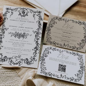 May include: A wedding stationery set with floral borders, including an invitation, details cards, and envelopes. The invitation features the names Isabella Rosina Caruso and Anthony James Mancini. One details card includes a QR code for further information.