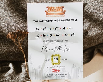 May include: A white invitation card featuring a cartoon illustration of the iconic orange sofa from the TV show "Friends". The text reads "The one where you're invited to a bridal shower in honour of the bride to be Meredith Lee. Sat. Aug. 29 at 3 o'clock in the afternoon. 780 Fifth St. New York, NY. RSVP to Raya at 555-555-555."