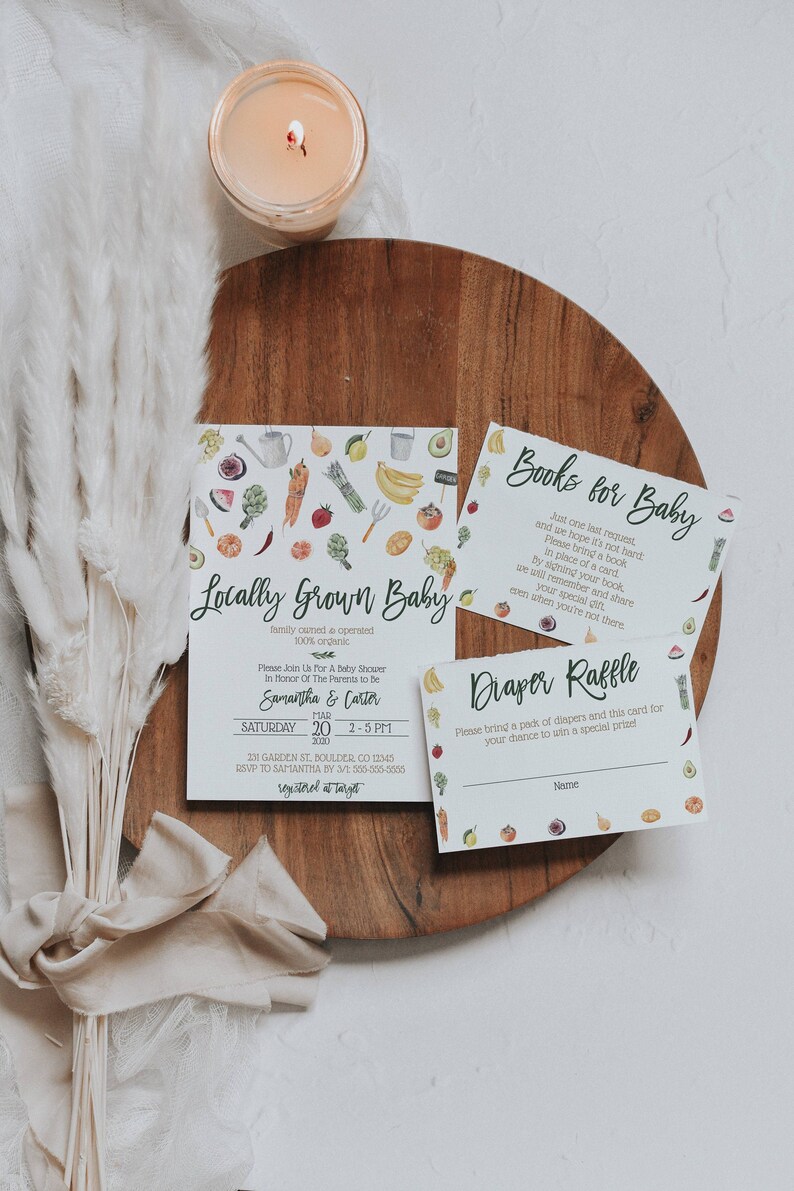 May include: A baby shower invitation with a green and white watercolor design featuring a variety of fruits and vegetables. The invitation reads "Locally Grown Baby" and includes the names Samantha and Carter, the date March 20, 2020, and the time 2-5 PM. The invitation also includes the address 231 Garden St, Boulder, CO 12345 and the RSVP information. There are two additional cards, one for a book raffle and one for a diaper raffle.
