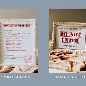 May include: Two framed signs with white woven-style frames. One reads "TONIGHT'S BRIEFING" with a list of topics. The other says "AUTHORIZED PERSONNEL ONLY DO NOT ENTER RESTRICTED AREA" in red text. Both are on a beige fabric.