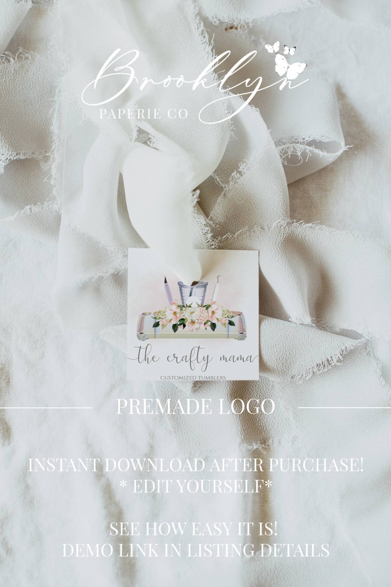 May include: A premade logo design for a business called "the crafty mama" that specializes in customized tumblers. The logo features a white background with a pink and white floral design and a tray with crafting tools. The text "the crafty mama" is written in a black script font.