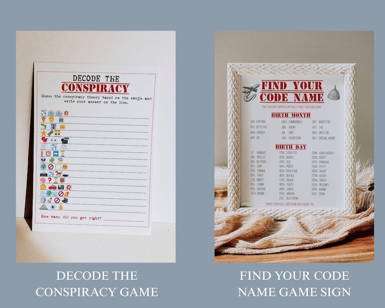 May include: Two game signs. One is a white paper with the text "DECODE THE CONSPIRACY" and a series of emojis. The other is a framed sign with the text "FIND YOUR CODE NAME" and a list of names. Both signs are on a light blue background.