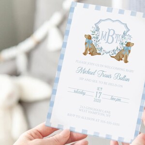 May include: A blue and white gingham baby shower invitation with a monogram and two dogs. The invitation reads "Please join us in welcoming baby Michael Travis Bolton. Sip and see to be held on Saturday, October 17, 2020 at two pm. 213 Gingham Lane, West Hampton, NY. RSVP to Allison at 553-555-5553."