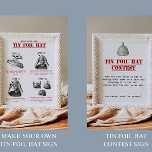 May include: Two framed signs with white woven frames. One sign reads "Make Your Own Tin Foil Hat" with step-by-step instructions. The other sign reads "Tin Foil Hat Contest" with contest rules. Both signs are on a wooden surface.