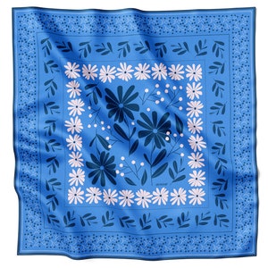 May include: A blue silk scarf with a white and dark blue floral pattern. The pattern features stylised flowers, leaves, and berries.