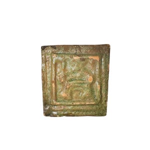 Tudor period green glazed clay tile depicting rampant wild cats, 16th century