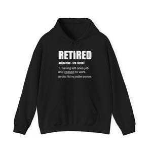 May include: Black hoodie with the word "RETIRED" in white capital letters. The hoodie includes a definition of the word. The sweatshirt has a front pocket and a drawstring hood. The text reads "Not my problem anymore."