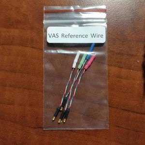 May include: A clear plastic bag containing several multi-colored VAS Reference Wires. Each wire has a different colored end, including white, green, blue, and pink. The wires are twisted together and have gold-colored tips.