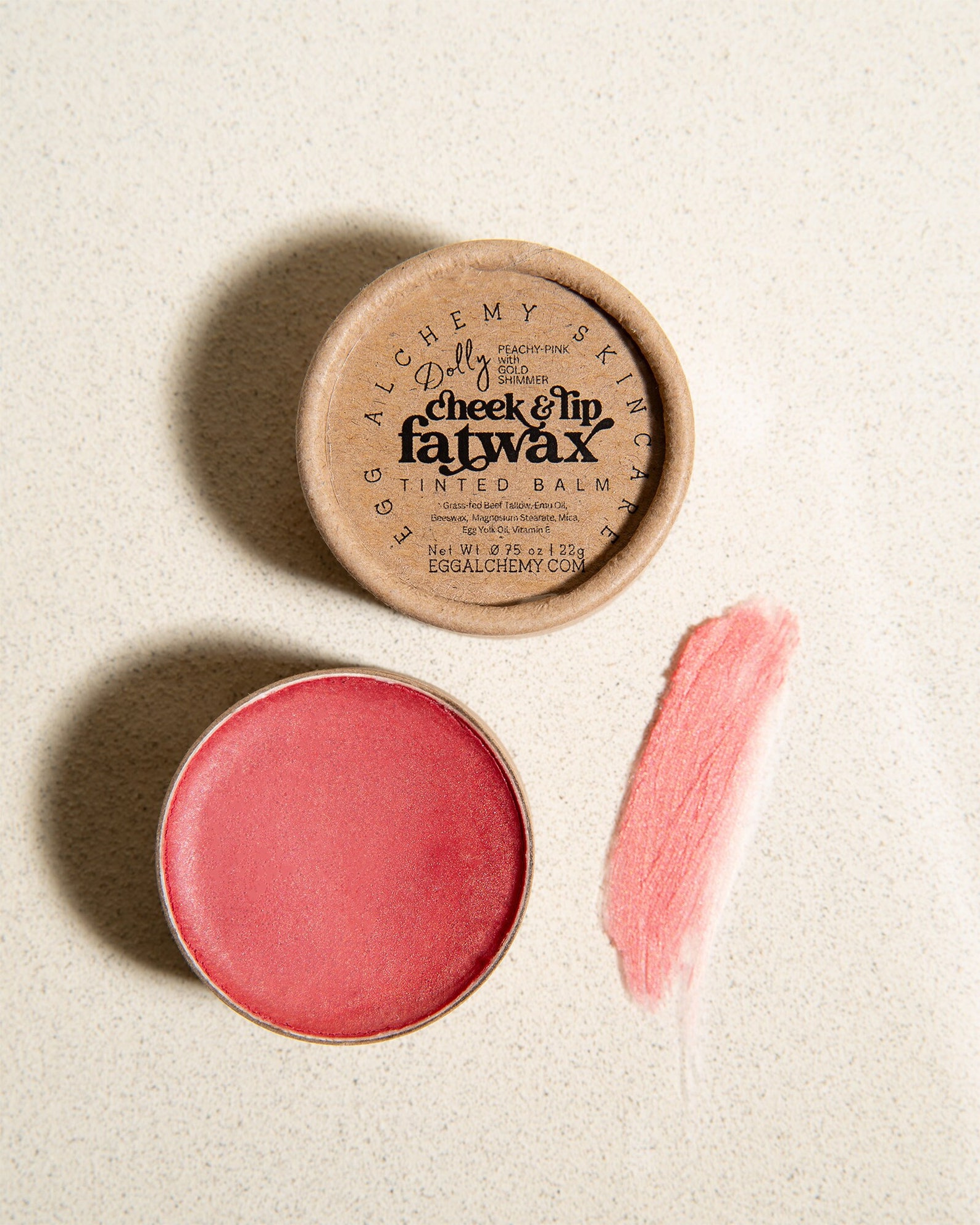 A package and swatch of a pink cheek and lip balm