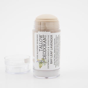 May include: A white deodorant stick with a label that reads "EGG ALCHEMY SKINCARE TALLOW DEODORANT EXTREMELY GENTLE & EFFECTIVE BAY LEAF LAVENDER" and lists the ingredients. The deodorant is in a clear plastic container with a twist-up mechanism.