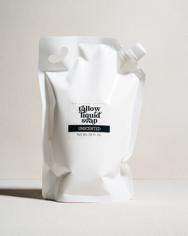 May include: White plastic pouch with a black label that reads "tallow liquid soap unscented" and "Net Wt. 36 Fl. Oz."
