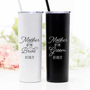 Your choice of mother of the bride or groom tumbler. 20 ounce stainless steel tumbler with lid and matching straw. Shown left to right: white mother of the bride tumbler personalized with wedding date. Matte black mother of the groom tumbler.