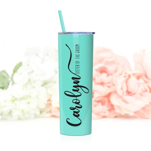 Personalized sister of the groom stainless steel tumbler shown in Mint. 20 ounce tumbler with lid and matching straw. Black print with inscription Carolyn in a cursive elegant font.
