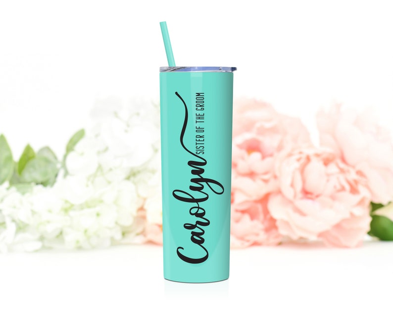 Personalized sister of the groom stainless steel tumbler shown in Mint. 20 ounce tumbler with lid and matching straw. Black print with inscription Carolyn in a cursive elegant font.