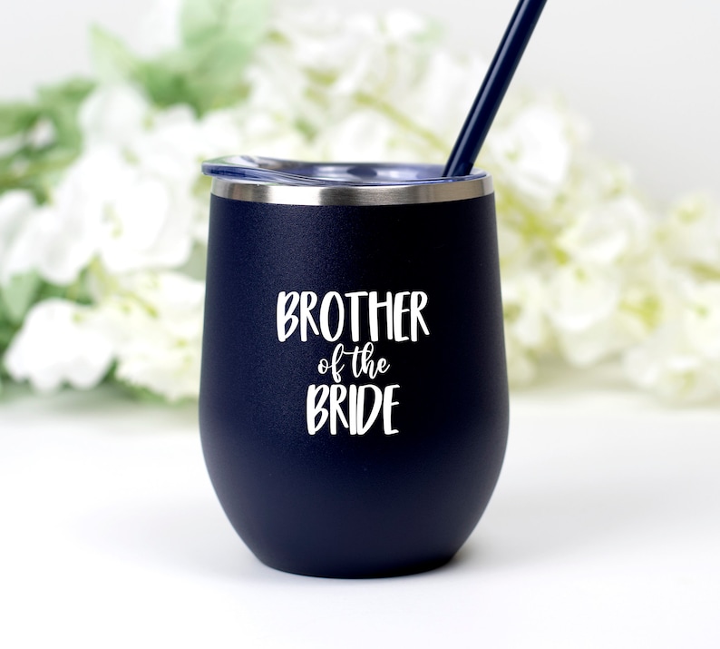 May include: A navy blue stainless steel tumbler with a white lid and a white inscription that reads "Brother of the Bride".