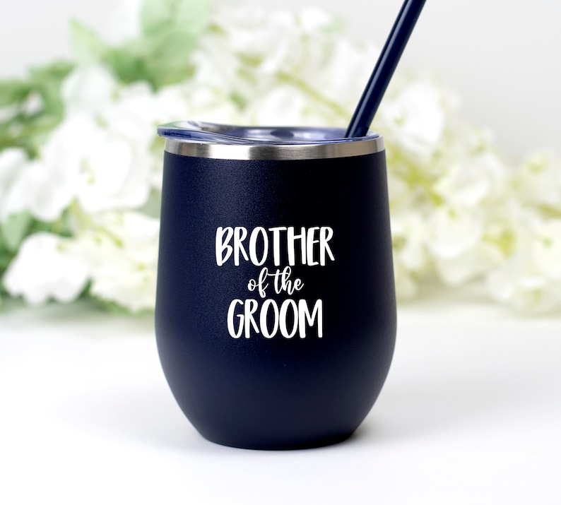 May include: A navy blue stainless steel tumbler with a white lid and a white inscription that reads "Brother of the Groom".