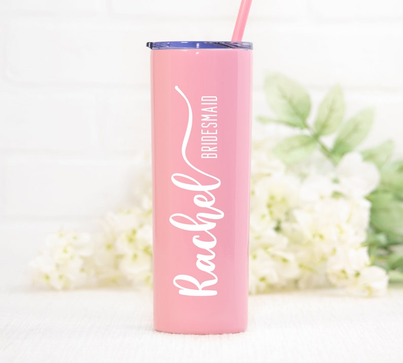 20 ounce stainless steel bridesmaid tumbler personalized with UV print name and optional title.  Shown in pink with white print.  Includes straw and lid. Made with direct UV print personalization.