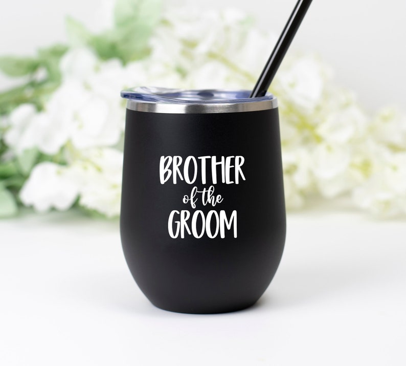 May include: Black stainless steel tumbler with a white inscription that reads "Brother of the Groom".