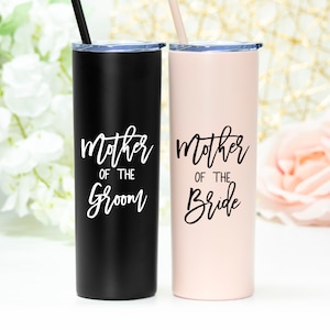 20 ounce stainless steel mother of the bride tumbler shown in matte blush with black print, with lid and straw. Also, shown is matte black tumbler with white print for Mother of the groom