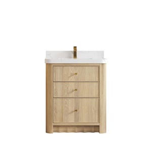 May include: A light wood bathroom vanity with three drawers and a white countertop. The vanity has gold-colored hardware and a gold faucet. The wood grain is visible on the drawers.