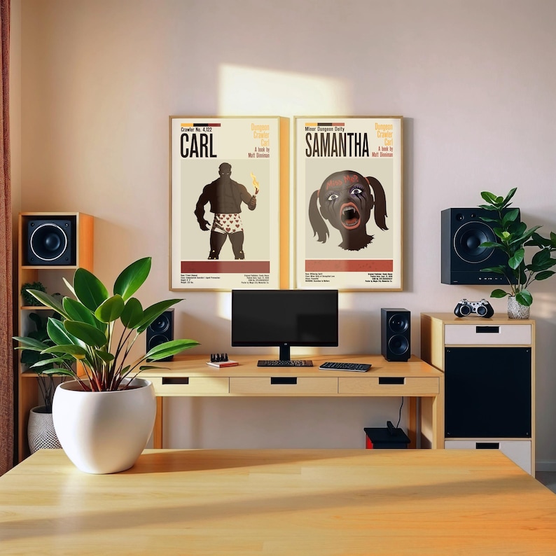 May include: A home office setup featuring a light wood desk with a computer, speakers, and two framed posters. The posters display the names "Carl" and "Samantha" with stylized illustrations. A potted plant and a wooden shelf with a speaker are also visible.