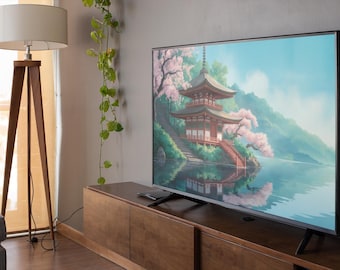 Può includere: Una grande TV a schermo piatto mostra un sereno dipinto di paesaggio di una pagoda giapponese vicino a un lago, con fiori di ciliegio e montagne. La TV è su un mobile in legno.