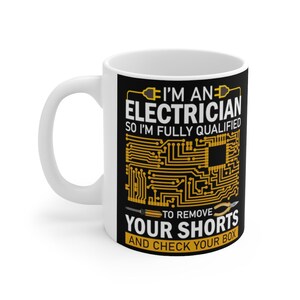 May include: White ceramic mug with a black background and gold text. The text reads "I'm an electrician so I'm fully qualified to remove your shorts and check your box". The text is surrounded by a circuit board design.