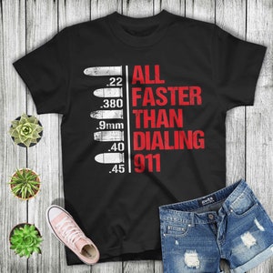 May include: Black t-shirt with a red graphic of bullets and the text "ALL FASTER THAN DIALING 911".