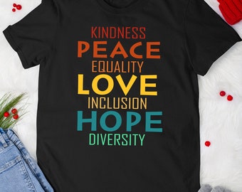 May include: Black t-shirt with a vintage-style graphic design featuring the words "Kindness, Peace, Equality, Love, Inclusion, Hope, Diversity" in rainbow colors.