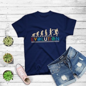 May include: A navy blue t-shirt with a graphic of the evolution of man culminating in a person bowling. The text "EVOLUTION" is printed in a retro style with a bowling pin graphic.