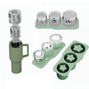 May include: Three green silicone ice cube trays with star-shaped molds. One tray has three molds, another has two, and the third has one. The trays are filled with clear ice cubes.