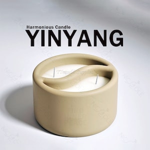 May include: A beige candle shaped like the yin yang symbol with two wicks. The candle is labeled "Harmonious Candle YINYANG".