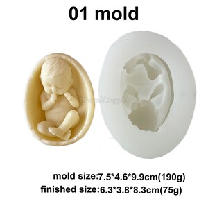 May include: A white silicone mould for making a baby figurine. The mould is 7.5 cm by 4.6 cm by 9.9 cm and weighs 190 grams. The finished figurine is 6.3 cm by 3.8 cm by 8.3 cm and weighs 75 grams.